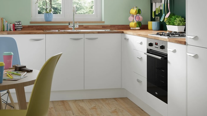 Sink and tap underneath a window in a Dakota White Kitchen